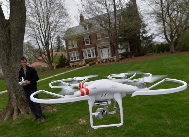 Mark Monge demonstrates the use of his drone he uses to photograph homes for his work as a Realtor in Peoria. File/GateHouse Media Illinois