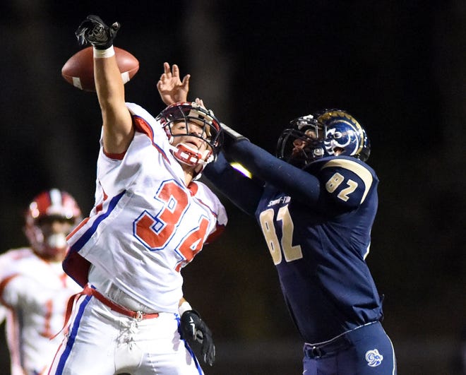 Neshaminy's Ben Stern (34) attempts to deflect a pass intended for Spring-Ford's Lee Albert (82) during a playoff game at Spring-Ford on Friday, Nov. 13, 2015. Neshaminy won 31-16.