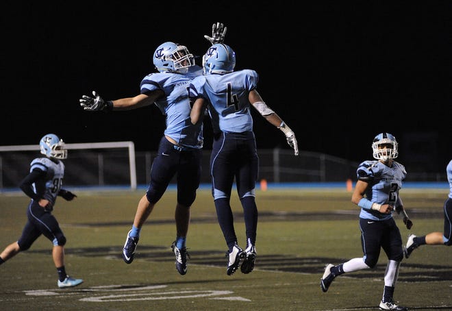 Kurt Reinstadtler (5) and Kyle Vreen (4) celebrate a touchdown by Vreen during their playoff game against Hampton Friday.