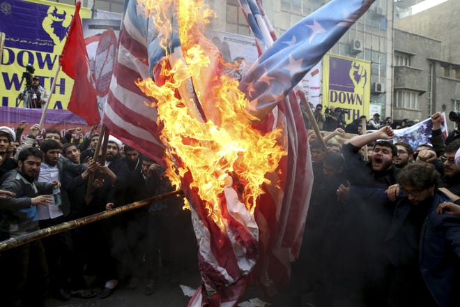 Iranian demonstrators burn the U.S. flag on Oct. 4, during an annual rally in front of the former U.S. Embassy in Tehran. AP PHOTO