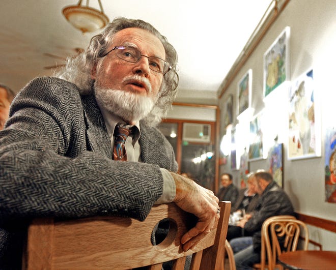 Michel Duncan Merle, a native of Paris and retired Worcester State University art professor, talks Saturday about the deadly terrorist attacks in Paris. He is in Espress Yourself Coffee at 2 Richmond Ave., Worcester. T&G Staff/Steve Lanava