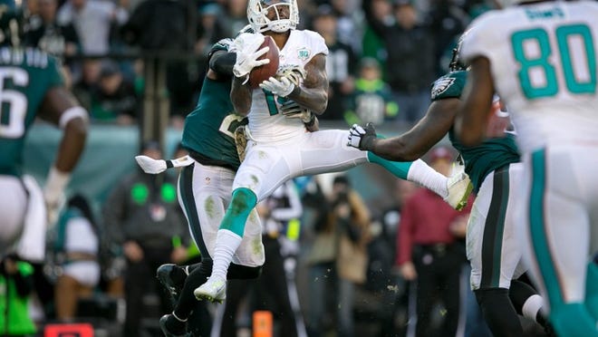 Miami Dolphins wide receiver Jarvis Landry (14) out leaps Philadelphia Eagles free safety Malcolm Jenkins (27) to catch a deflected pass for a touchdown to give the Dolphins the lead at Lincoln Financial Field in Philadelphia, Pennsylvannia on November 15, 2015. (Allen Eyestone / The Palm Beach Post)