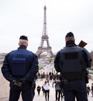 Police officers patrol at Place du Trocadero near the Eiffel Tower on Nov. 14, 2015 in Paris, France. At least 120 people were killed in a series of terrorist attacks in Paris. (Marius Becker/DPA/Abaca Press/TNS)