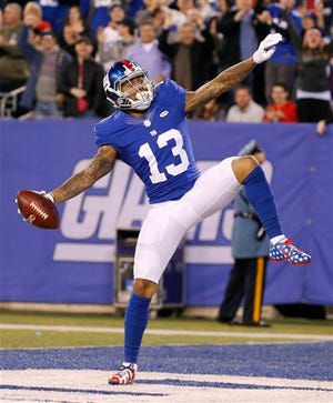 New York Giants wide receiver Odell Beckham celebrates after scoring a touchdown during the first half of an NFL football game against the New England Patriots Sunday Nov. 15, 2015, in East Rutherford, N.J. (AP Photo/Julio Cortez)