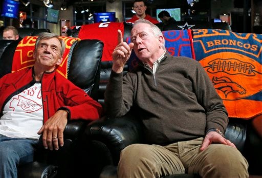 Doug Smith, left, father of Kansas City Chiefs quarterback Alex Smith, talks to Archie Manning, father of Denver Broncos quarterback Peyton Manning and New York Giants quarterback Eli Manning, during halftime of an NFL football game in which the Chiefs faced the Broncos, Sunday, Nov. 15, 2015, in New York. (AP Photo/Kathy Willens)