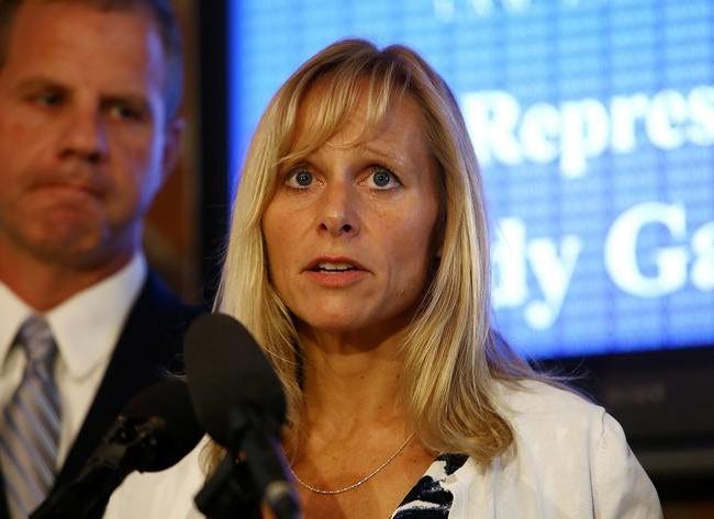 Representative Cindy Gamrat addresses the media with an apology at Abood Law Firm in Lansing, Mich., Friday, Aug. 14, 2015. The embattled but apologetic Michigan lawmaker who had an extramarital affair with another married legislator said Friday she will not resign from office for now and denied any role in a bizarre, fictional email sent to deflect attention from their relationship. (Danielle Duval/Jackson Citizen Patriot via AP)