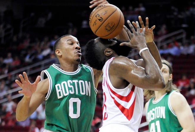 Boston Celtics defender Avery Bradley (0) knocks the ball away from Houston Rockets forward James Harden in the first half of their game Monday in Houston. Photo by AP