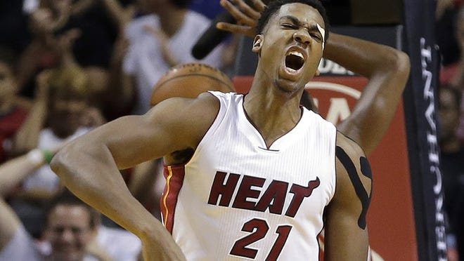 Miami Heat center Hassan Whiteside (21) celebrates after scoring against the Houston Rockets in the first half of an NBA basketball game, Sunday, Nov. 1, 2015, in Miami. (AP Photo/Alan Diaz)