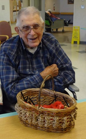 A resident gathers poppies in a basket to be delivered. Courtesy photo