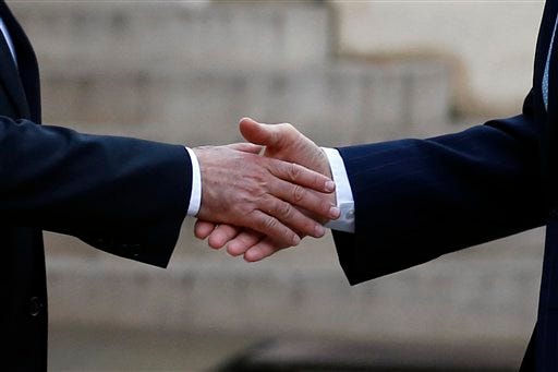 French President Francois Hollande, left, shakes hands with US Secretary of State John Kerry, upon arrival at the Elysee Palace, in Paris, France, Tuesday, Nov. 17, 2015. Kerry arrived in Paris to pay tribute to last Friday November 13 attacks in France. (AP Photo/Francois Mori)