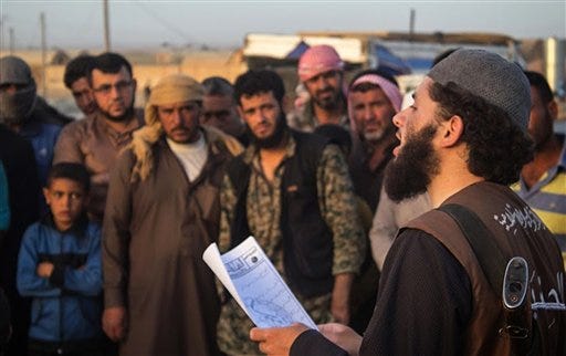 FILE -- In this file photo released May 14, 2015 by a militant website, which has been verified and is consistent with other AP reporting, a member of the Islamic State group'sÂ vice police known as "Hisba," right, reads a verdict handed down by an Islamic court sentencing many they accused of adultery to lashing, in Raqqa City, Syria. Islamic State militants are barricading down for a possible assault on their de facto capital Raqqa, hiding among civilian homes and preventing anyone from fleeing, as international airstrikes intensify on the Syrian city in the wake of the Paris attacks. For many, the threat of missiles and bombs from the enemies of Islamic State is more of an immediate threat than the vicious oppression of the jihadis"™ themselves. (Militant website via AP, File)