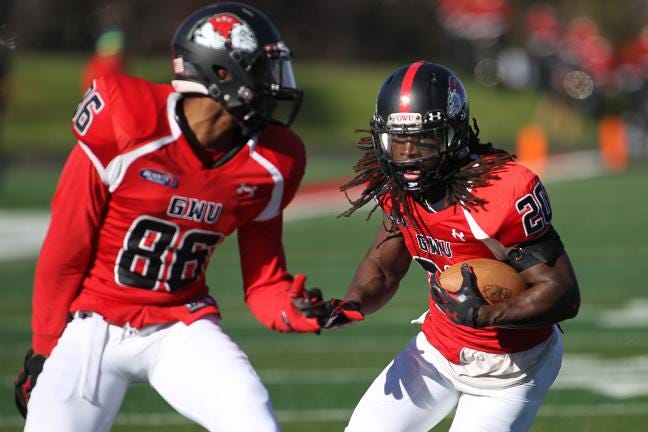 GWU ballcarrier Bobby Clark, right, gets an escort from 'Dogs wideout Adonus Lee, 86, in last Saturday's win against ETSU. Gardner-Webb will host Monmouth University this Saturday to close out the seaosn.