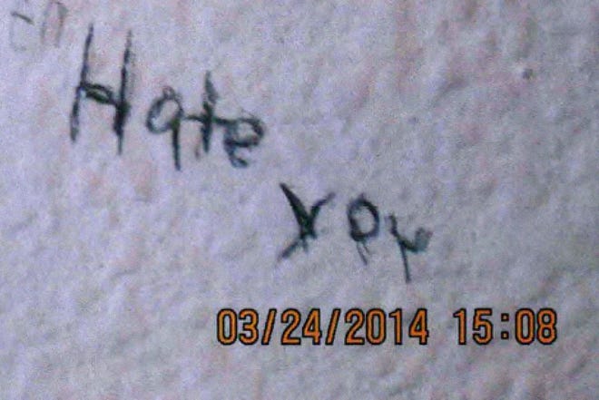 This image from evidence gathered by the Naval Criminal Investigative Service during its investigation of Navy Petty Officer 1st Class Darren Yazzie, and obtained by The Associated Press, shows a message written by his victim on a bedroom wall. Yazzie was convicted in January 2015 of rape of a child and sentenced to 17 years confinement. (Naval Criminal Investigative Service via AP)