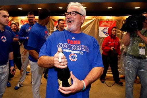 FILE - In this Oct. 7, 2015, file photo, Chicago Cubs manager Joe Maddon waits for pitcher Jake Arrieta to arrive in the locker room to begin celebrating a 4-0 win over the Pittsburgh Pirates in the National League wild card baseball game in Pittsburgh. Joe Maddon has won his third Manager of the Year award, earning his first in the NL after guiding the Chicago Cubs to their first postseason berth since 2008. Maddon got nine first-place votes for 124 points from the Baseball Writers' Association of America in balloting announced Tuesday, Nov. 17, 2015.(AP Photo/Gene J. Puskar, File)