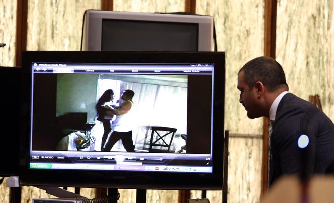 Defense attorney Saam Zangeneh, right, looks at a 2012 or earlier video of the murder victim Jennifer Alfonso and defendant Derek Medina, making contact in a home surveillance video during day five of Medina's murder trial Tuesday, Nov. 17, 2015 in Miami. He is accused of murdering his wife in August 2013 and then posting a photo of her body on Facebook. He claims self defense.