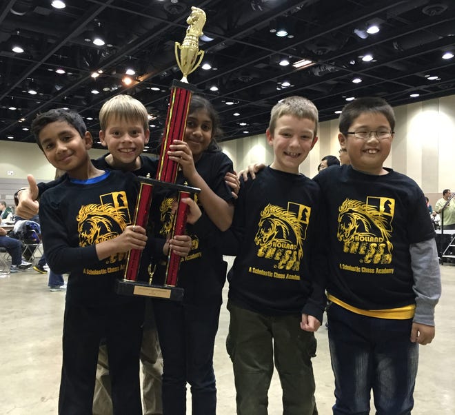 The K-3 team of the Holland Chess Club pose with their trophy after taking home first place at a state tournament in Lansing Saturday, Nov. 14, 2015. Contributed
