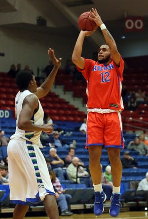Hutchinson Community College's Tyler Kohl (12) hits a 3-pointer over Western Texas' Jeffrey Uju (1) during the first half of their game on Friday, Nov. 20, 2015, at the Sports Arena.