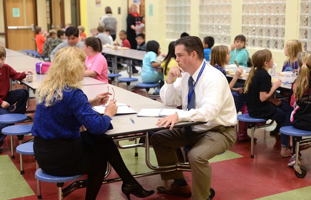Chance Lambeth, deputy director of the 7th Congressional District, speaks with Pam Smith, Lenoir County Public Schools nutrition director, at Pink Hill Elementary School on Thursday.