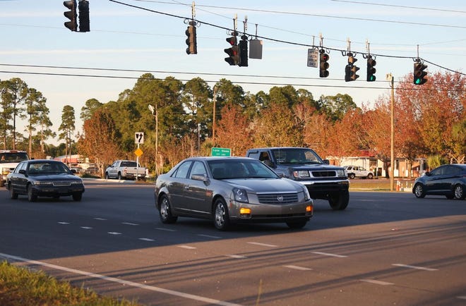 Vehicles are driven through the intersection of Baldwin Road and State Road 77 on Nov. 20. (Patti Blake | The News Herald)