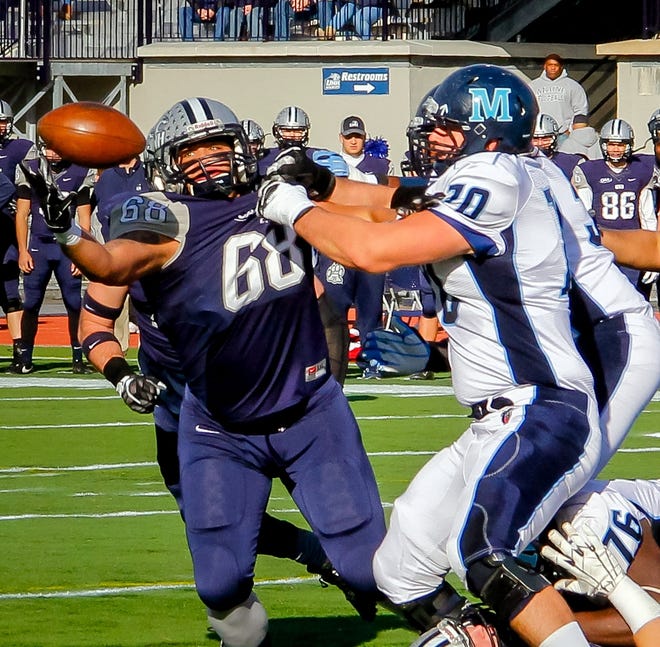 UNH's Cyrus Boone (68) grabs this fumble in mid-air for a turnover during Saturday's game against Maine at Cowell Stadium. Shawn St. Hilaire/Fosters.com