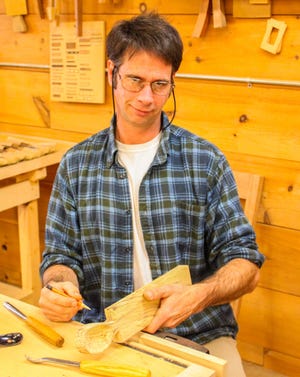 Matt Wajda of River City Furniture Making crafts a wooden spoon during the Open Mills event at the Salmon Falls Mills in Rollinsford on Saturday. Photo by AJ St.Hilaire/Fosters.com