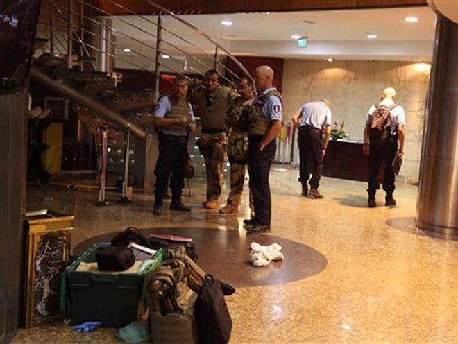 French troops, rear, inside the Radisson Blu hotel after an attack by gunmen on the hotel in Bamako, Mali, Friday, Nov. 20, 2015. Islamic extremists armed with guns and grenades stormed the luxury Radisson Blu hotel in Mali's capital Friday morning, and security forces worked to free guests floor by floor.