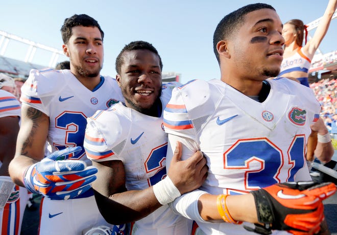 Florida tight end DeAndre Goolsby (30), running back Kelvin Taylor (21) and defensive back Jalen Tabor (31) celebrate after the game last Saturday against South Carolina at Williams-Brice Stadium in Columbia, S.C. Florida defeated South Carolina 24-14.