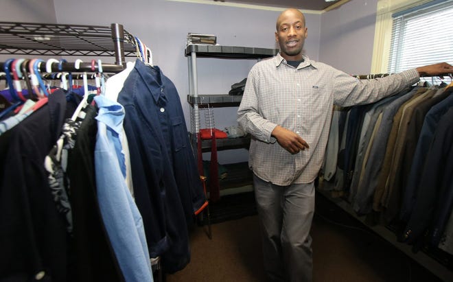 United Way of Sullivan County executive director Julian Dawson among donated clothing at the United Way office in Monticello. Dawson is the agency's only employee. JIM SABASTIAN/FOR THE TIMES HERALD-RECORD