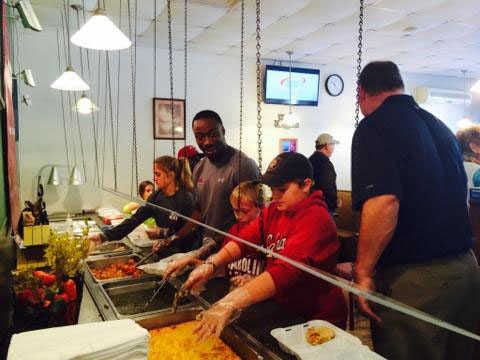 Jasper County Sun Times file photo. Marcus Lattimore helps serve a Thanksgiving meal last year at the Bar-B-Q Grill.