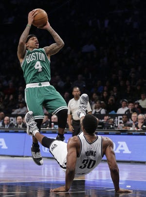 Brooklyn Nets forward Thaddeus Young (30) falls backward and draws an offensive foul from Boston Celtics guard Isaiah Thomas in Sunday night's game. Julie Jacobson/Associated Press