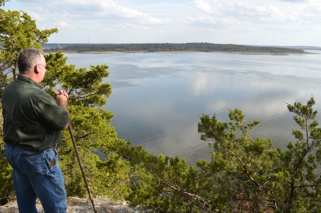 Superintendent Bryan Bethel admires the view from the new 1,000th Mile Trail at Truman State Park.