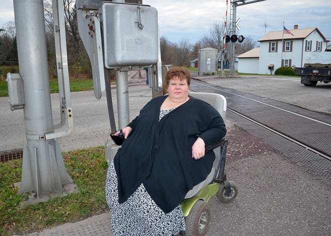 Patty Grebiner, of Albion, is shown alongside the Canadian National Railway tracks where her wheelchair became stuck in small pebbles along the tracks on Oct. 22. VALERIE MYERS/Erie Times-News