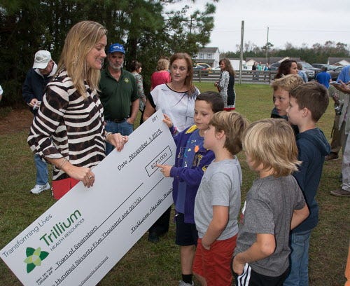 Brittany Shipp, Director of Swansboro Parks and Recreations, talks to Spencer Humphrey, Nolan Armstrong, Garrett Panos, Brody Denham, and Fletcher Panos about the Trillium Health Resources Play Together Construction Grant. The town has been awarded a $275,000 grant from Trillium Health Resources that will fund the purchase of inclusive equipment, including a Liberty Swing, which is a swing accessible for anyone in a wheelchair.