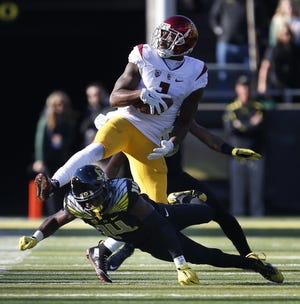 Oregon's Ugo Amadi tackles USC receiver Darreus Rogers during the first quarter at Autzen Stadium in Eugene on Saturday, November 21, 2015. (Andy Nelson/The Register-Guard)