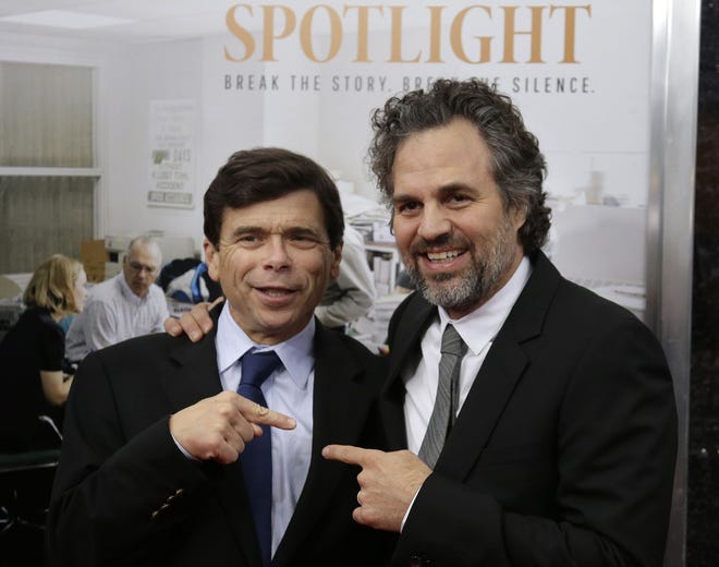 Pulitzer Prize-winning investigative reporter Michael Rezendes, left, stands with actor Mark Ruffalo, who plays Rezendes in the film "Spotlight," at the Boston area premiere of the film Oct. 28. The Associated Press