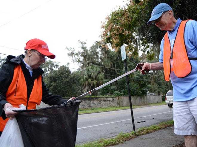 Seema Kramer and David Pawliger of the Jewish Council of North Central Florida pick up litter along Northwest Eighth Avenue during one of their bi-monthly walks that fell on UF Mitzvah Day on Nov. 22, 2015. On Mitzvah Day, volunteers went out into the community to perform a number of service projects around Gainesville.