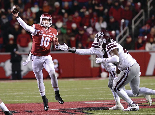 BRIAN D. SANDERFORD • TIMES RECORD Arkansas quarterback Brandon Allen gets a pass off to Drew Morgan as he’s pressured by Mississippi State’s Ryan Brown, right, and Beniques Brown on Saturday, Nov. 21, 2015 at Reynolds Razorback Stadium.