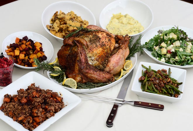 A Thanksgiving meal prepared by Spartanburg Marriott executive chef Jason Ober. In the center is a roasted ginger and lemon turkey. Sides are , from left to right, a baked sweet potato mixed with dried cranberries and topped with a cobbler topping mixed in with pecans; apple and orange cranberry relish; a golden red beet blend with roasted butternut squash; wild mushroom and sausage cornbread dressing; garlic and chive mashed potatoes; young spring kale mix with apples, pears, feta cheese, cashews and red onion; crystallized onions and candied walnuts sautéed green beans. ALEX HICKS JR./alex.hicks@shj.com