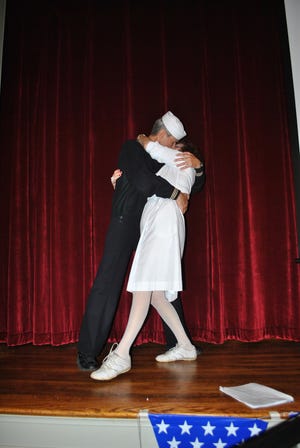 Joan Scheer as the nurse and Norm Paquin as the sailor in a re-enactment of "The Kiss" during a fundraiser for Hamilton House, Adult Learning Exchange held Nov. 8, 2015.