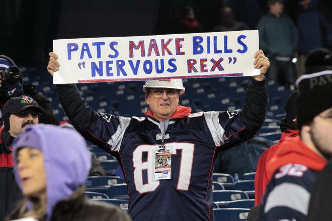 A Patriots fan holds up a sign prior to the start of Monday night's game.