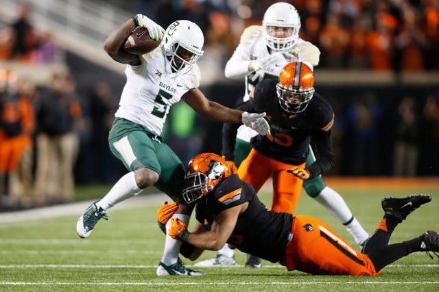 Baylor Bears running back Johnny Jefferson (5) is tackled by Oklahoma State Cowboys linebacker Seth Jacobs (10) in the fourth quarter at Boone Pickens Stadium in Stillwater, Okla., on Saturday, Nov. 21, 2015. Baylor won 45-35. (Tim Heitman-USA TODAY Sports)