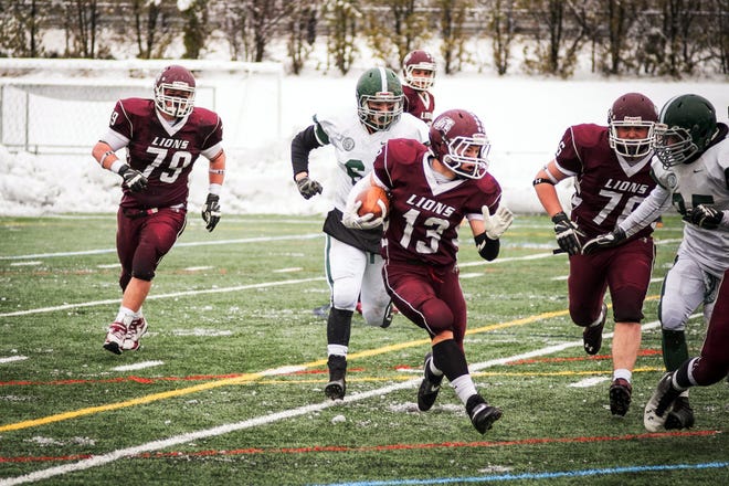 Chelmsord High senior Nick Philippon (13) rushes with the ball during the 2014 Thanksgiving day game against Billerica Memorial High School at Simonian Alumni Stadium in Chelmsford, Nov. 27, 2014.  (Wicked Local File Photo/Zara Tzanev)