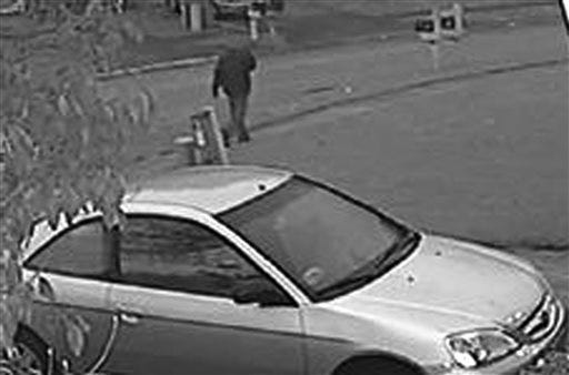 This frame grab from surveillance video provided by the Indianapolis Metropolitan Police Department shows a possible suspect walking in the neighborhood where an Indianapolis pastor's wife was shot. Police say Amanda Blackburn, 28, was shot in the head during an attack in her home on Nov. 10, 2015 and died the next day. She was 13 weeks pregnant. (Indianapolis Metropolitan Police Department via AP)