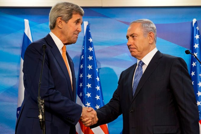 U.S. Secretary of State John Kerry, left, shakes hands with Israeli Prime Minister Benjamin Netanyahu before their meeting at the Prime Minister's Office in Jerusalem, Tuesday, Nov. 24, 2015. (AP Photo/Jacquelyn Martin, Pool)