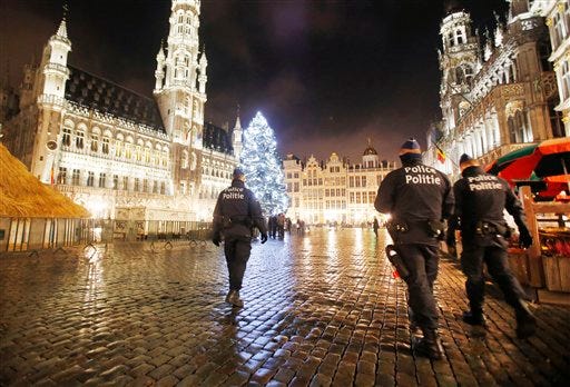 Belgian police officers patrol the Grand Place in downtown Brussels, Belgium, Monday, Nov. 23, 2015. The Belgian capital Brussels has entered its third day of lockdown, with schools and underground transport shut and more than 1,000 security personnel deployed across the country.