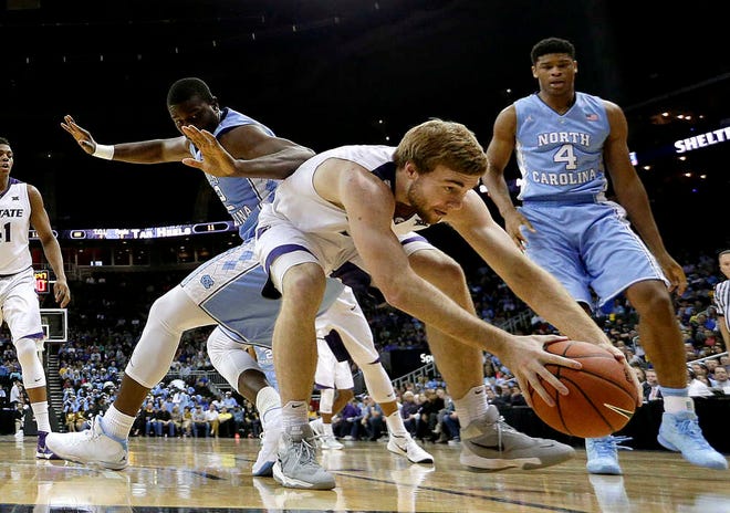North Carolina's Joel James, left, defends as Kansas State's Austin Budke chases a loose ball during the first half of Tuesday night's game at Sprint Center in Kansas City, Mo. K-State lost 80-70.