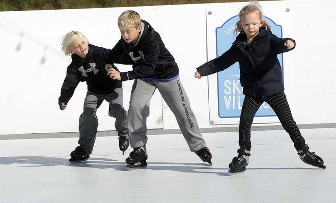 Photos by Terry.Dickson@jacksonville.com Brothers Grady Johnson (left), 9, and Griffin Johnson, 10, and Amelia Hood, 7, try out the new polymer ice skating rink overlooking the Atlantic on Jekyll Island.