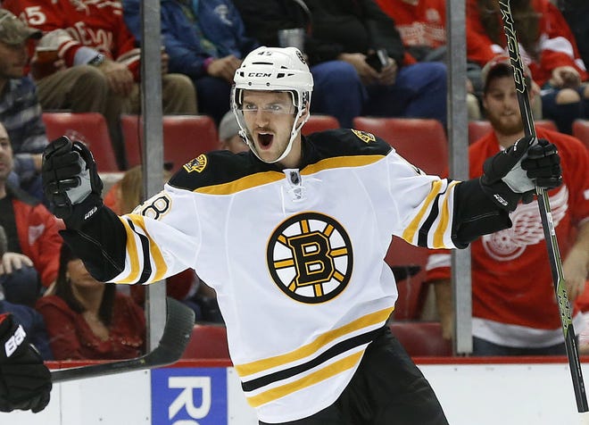 Boston defenseman Colin Miller celebrates his game-tying goal with 1:44 left in regulation.