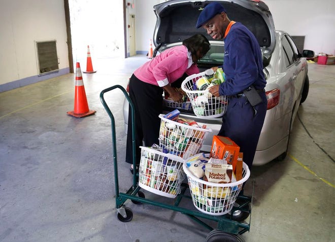 Rodney Long, right, helps Janice Crews of Hall Chapel United Methodist Church in Rochelle unload donated food during the Strike Out Hunger food drive, which also provided Thanksgiving baskets to those in need.