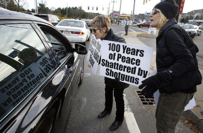 Jill Hallisey, of Boston, center, approaches a car during a demonstration in Canton to protest a planned deer hunt in the Blue Hills Reservation. A plan to allow hunting to cull an exploding deer population in a 7,000-acre swath of forest within sight of downtown Boston is under fire from activists who insist that more humane methods, including contraception or sterilization, be used.

AP Photo/Steven Senne
